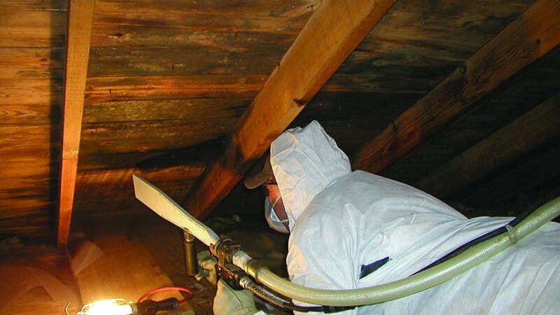 restoration worker using dry ice blaster to clean attic interior